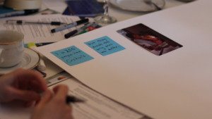 Image of PPGNY participant storyboard effort with two blue sticky notes and a photo 
