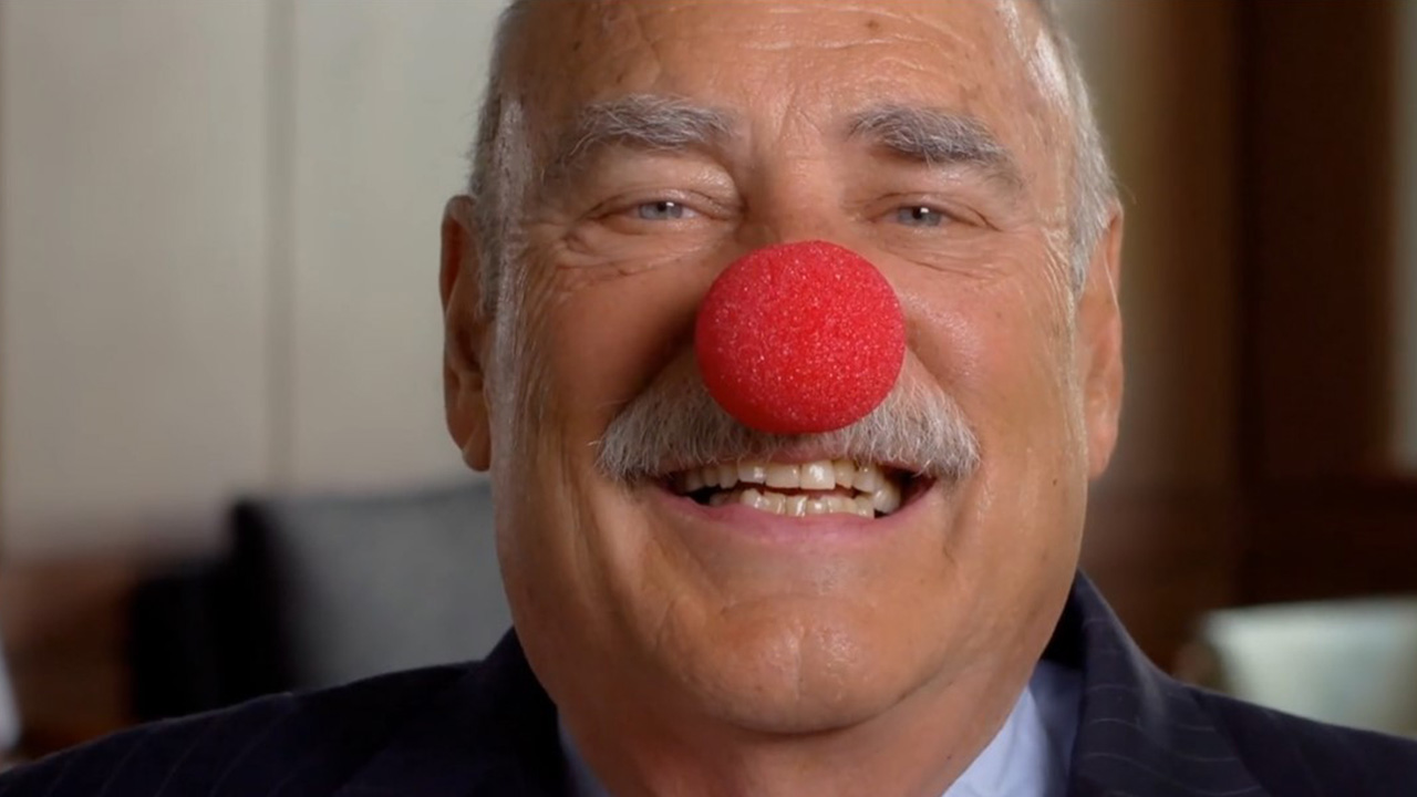 alumni giving video with planned giving donor chuck tatelbaum wearing red clown nose