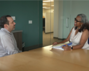 Thumbnail of a FMLA video for patients showing an employee and HR representative at an office table