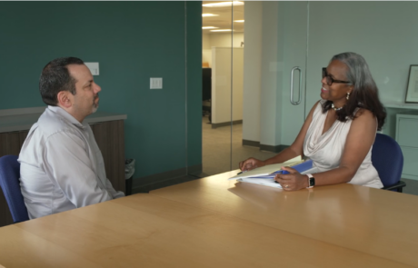 Thumbnail of a FMLA video for patients showing an employee and HR representative at an office table